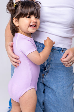 Flexisuit lavender bodysuit with long sleeves and fitted design, featuring a smooth, stretchy fabric for a sleek, stylish look.