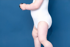 White Flexisuit bodysuit by Flexisuit, shown in the image, featuring a sleek, fitted design with long sleeves and high neckline.